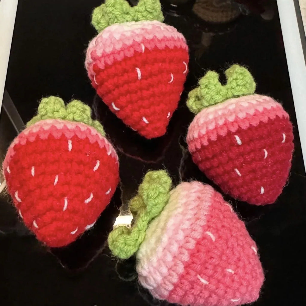 Soft plush strawberry-shaped pendant keychain in pink or red colour.