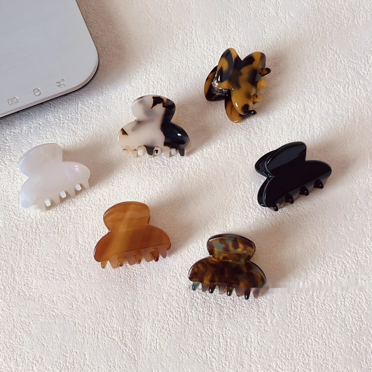 Mini jaw clip back head hairpin for women in acetic acid, shown in six colour options including coffee hawksbill and bright black.