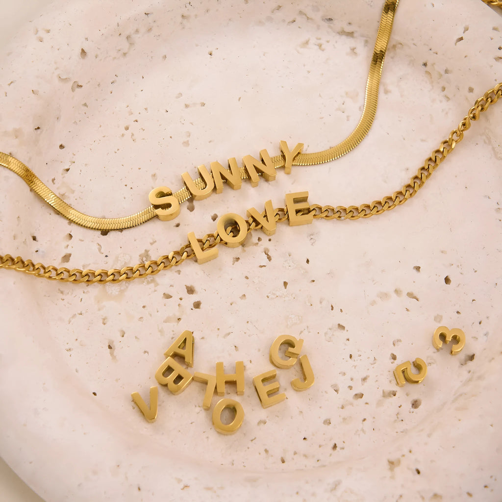 Gold titanium steel necklace with a letter A pendant on a 40.5cm chain.