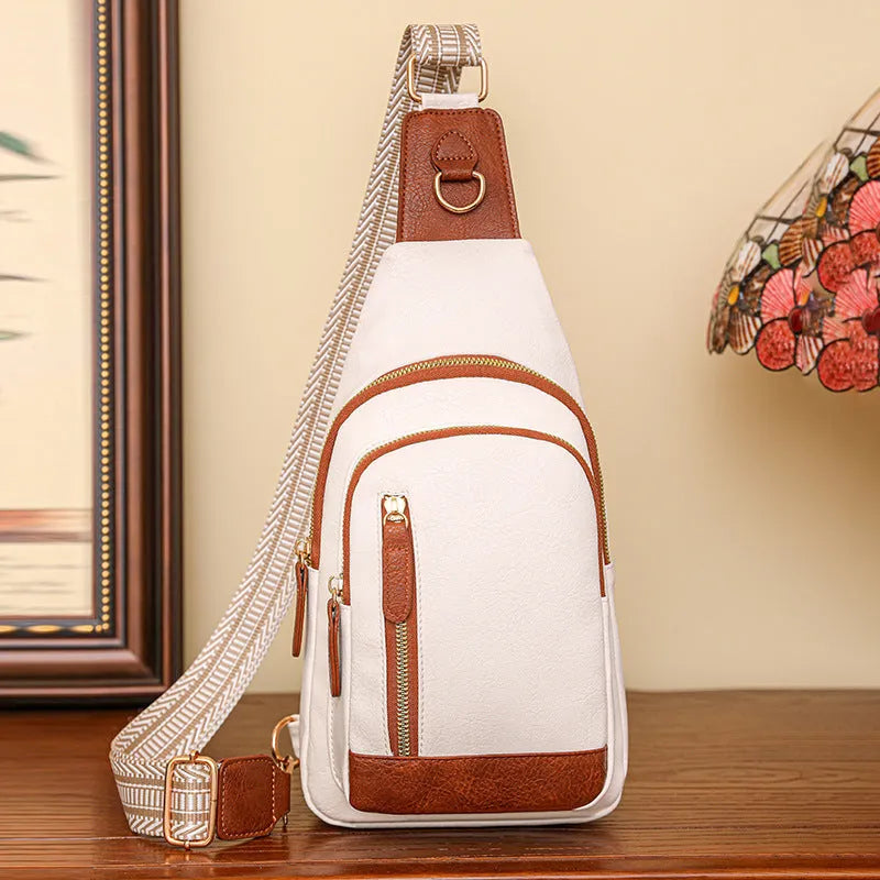 Soft PU women's crossbody chest bag in street style, showing internal zipper organisers.