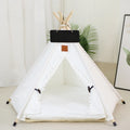 Striped flax and linen teepee tent pet bed for a small dog or cat, shown with a cushion inside.