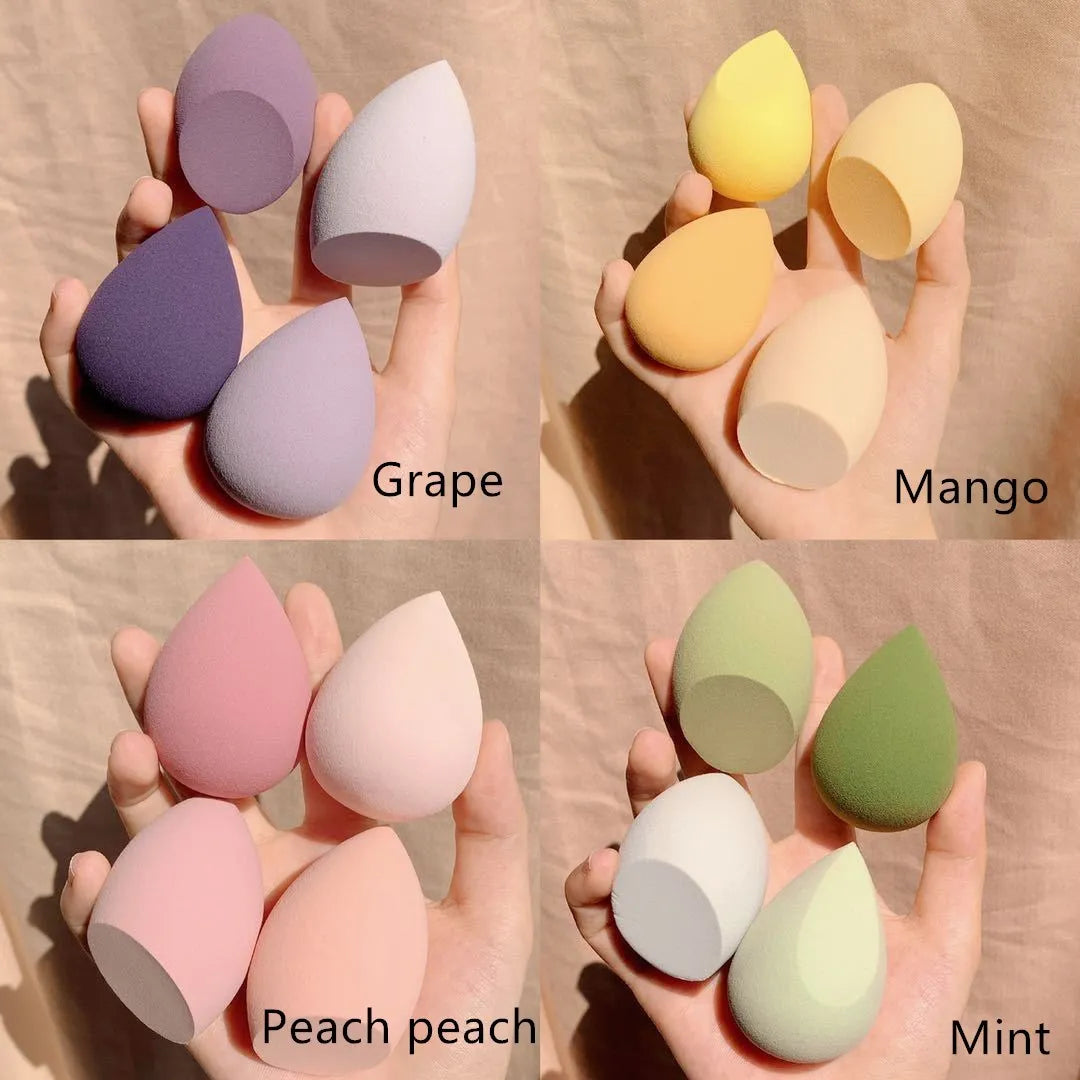 Set of four coloured makeup egg sponges in grape, mango, mint, and peach