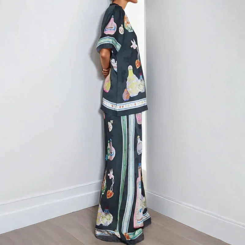 Black women's casual set with cartoon print, featuring a cardigan and trousers.