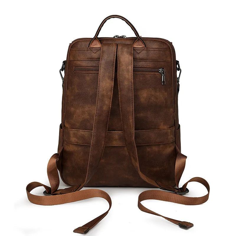 Solid-colour university backpack in PU leather with curved shoulder straps and minimalist stitching detail