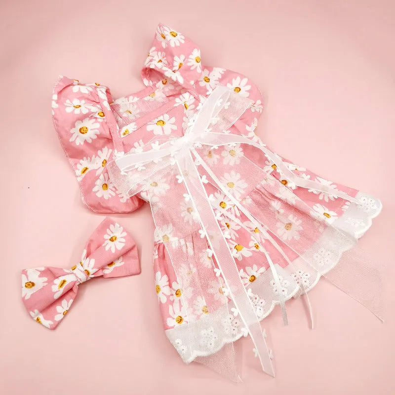 Breathable lace and plaid gauze dog skirt in Pink Daisy with matching bow necklace on a small dog