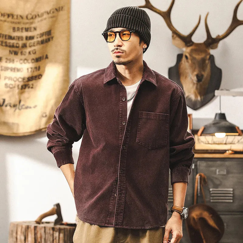 A man's loose-fit retro corduroy shirt jacket in red, featuring long sleeves and a button-front design.
