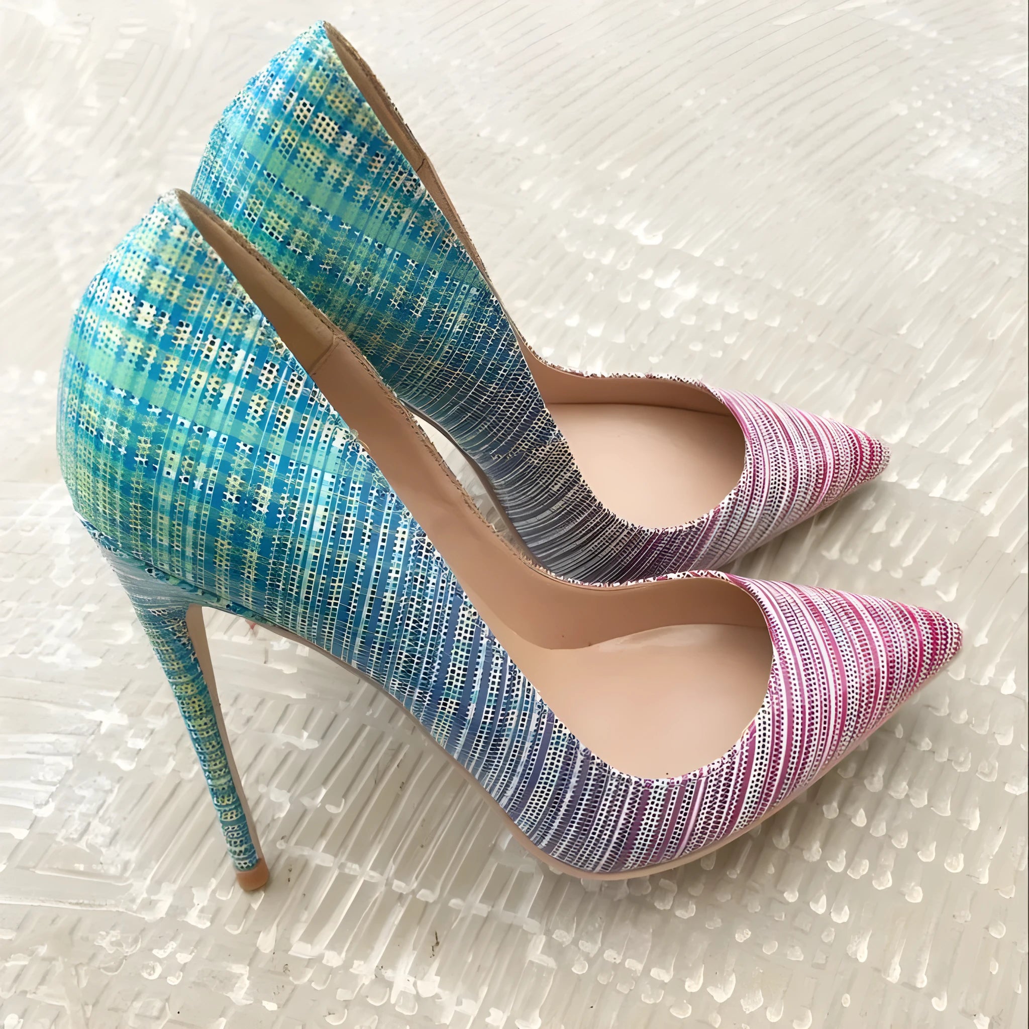 Ladies pink and blue gradient patent leather pointed toe high heels on a rubber sole.