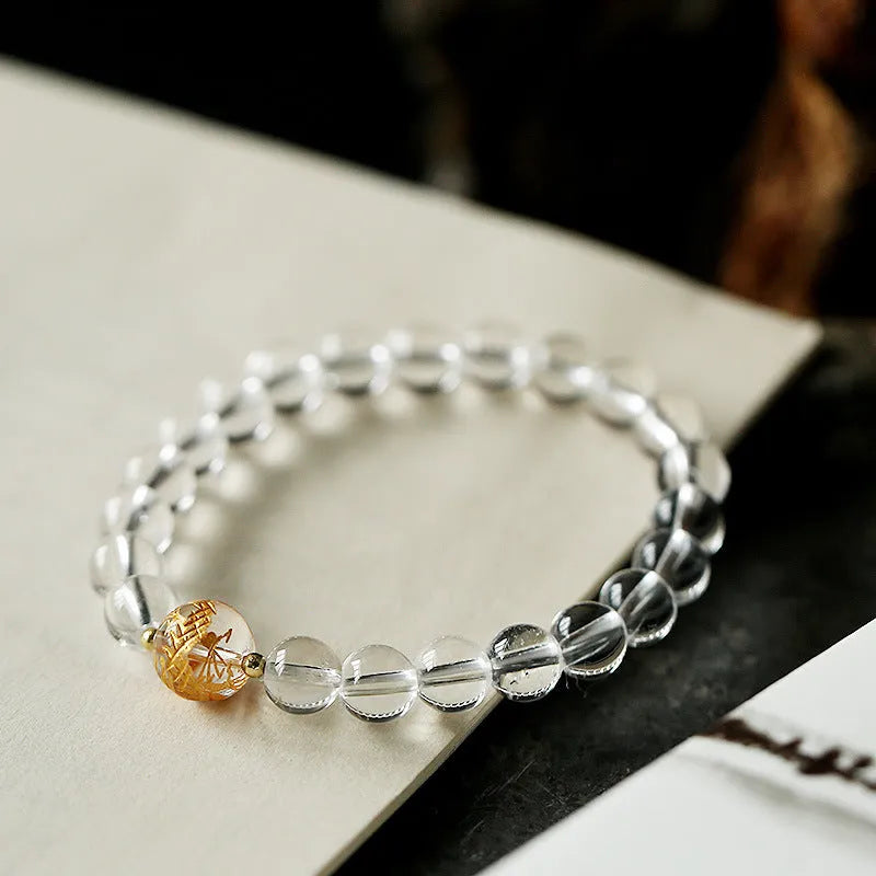 Unisex geometric bead bracelet with black obsidian agate and white crystal stones on a wrist