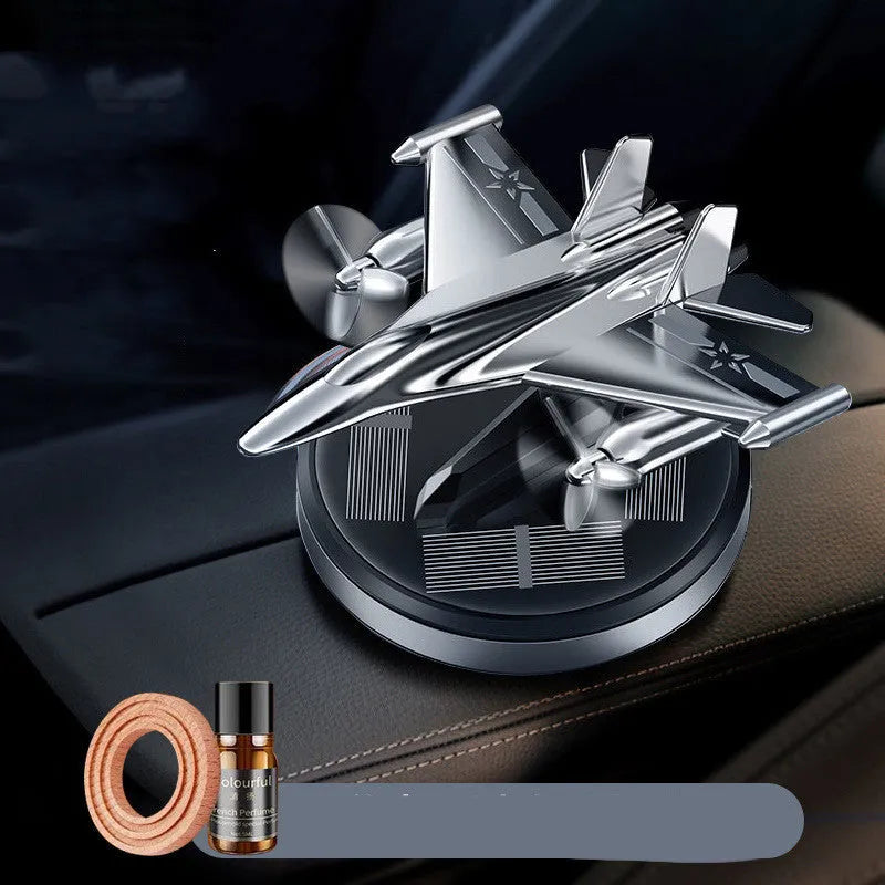 Solar powered rotating fighter aircraft perfume ornament in silver, gold, blue, or red colour.
