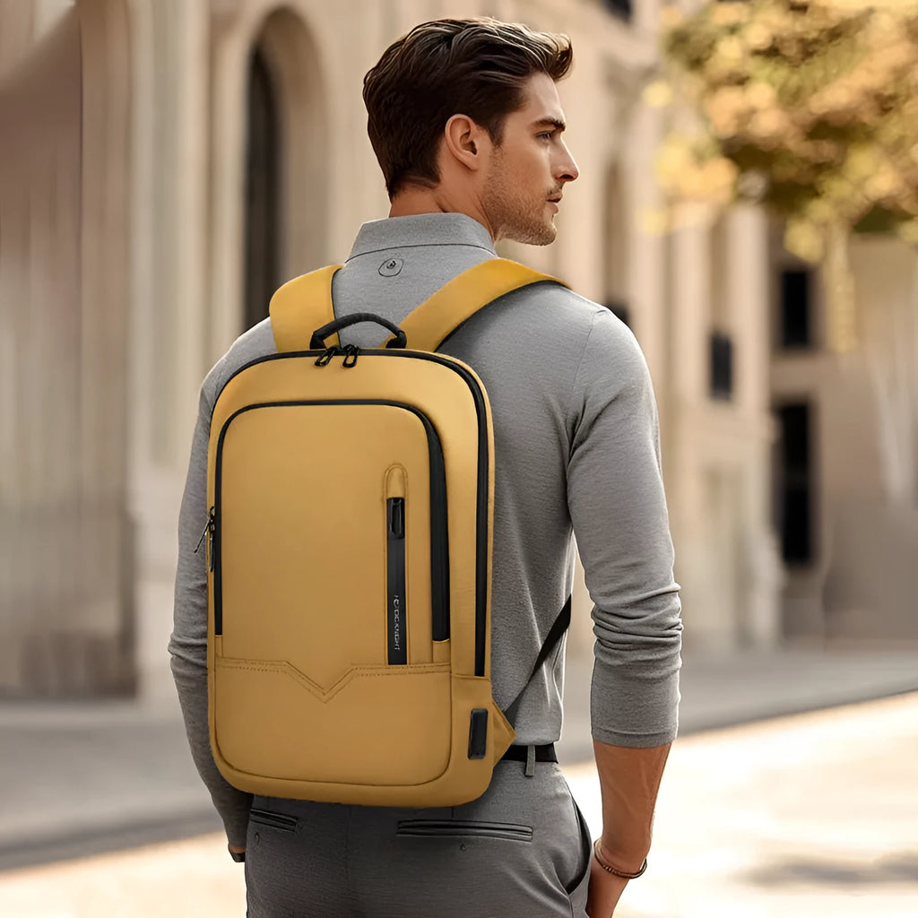 Lightweight solid colour polyester backpack with USB charging port for a laptop.