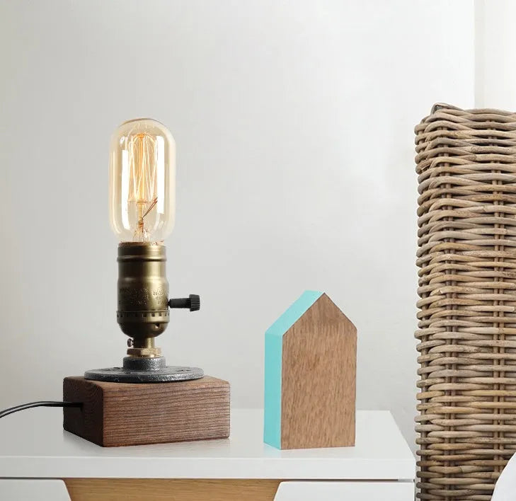 Wood and iron water pipe design table lamp on a surface