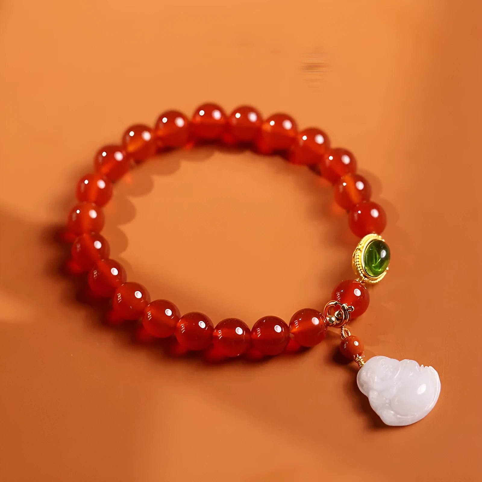 Red agate bracelet with ancient gold jade hanging element and Buddha pendant