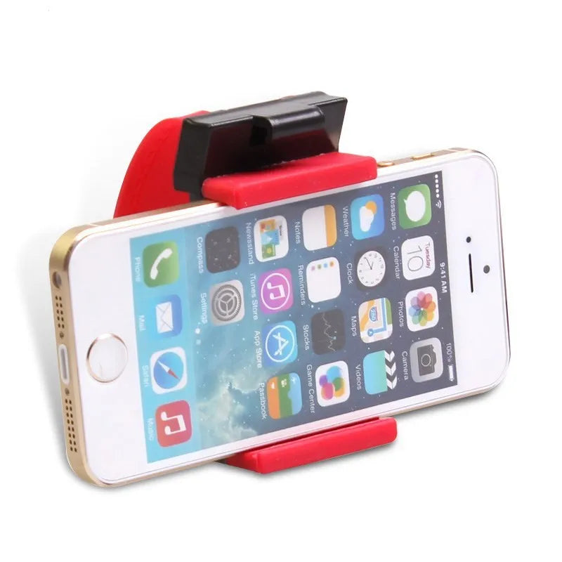Black universal steering wheel phone holder clip mounted on a car steering wheel, holding a smartphone.
