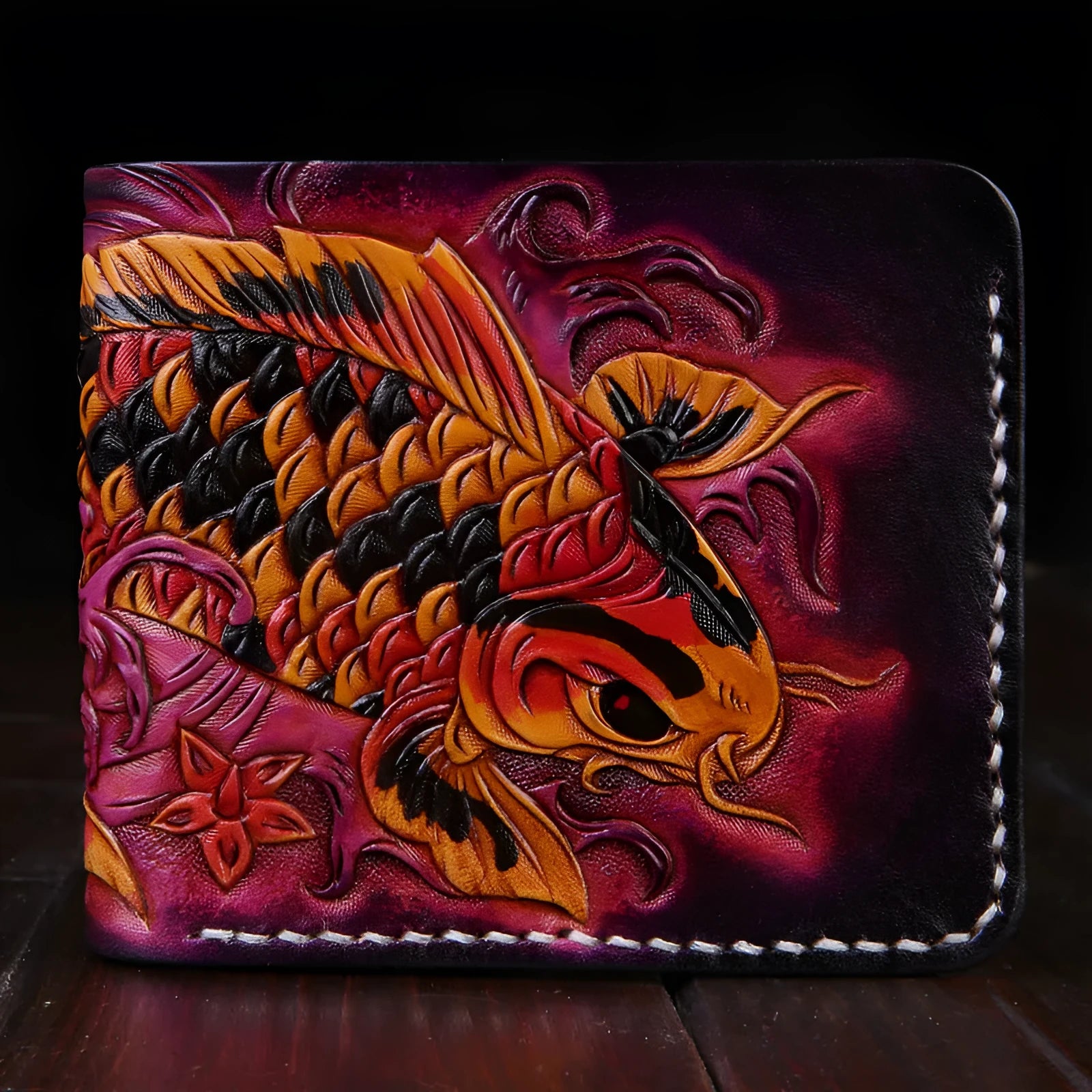 Hand-carved men's leather wallet in navy blue, showing slim profile and open design on a wooden table.
