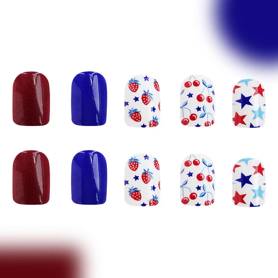 Short glossy false nails with red and blue strawberry cherry pattern, 24 piece set.