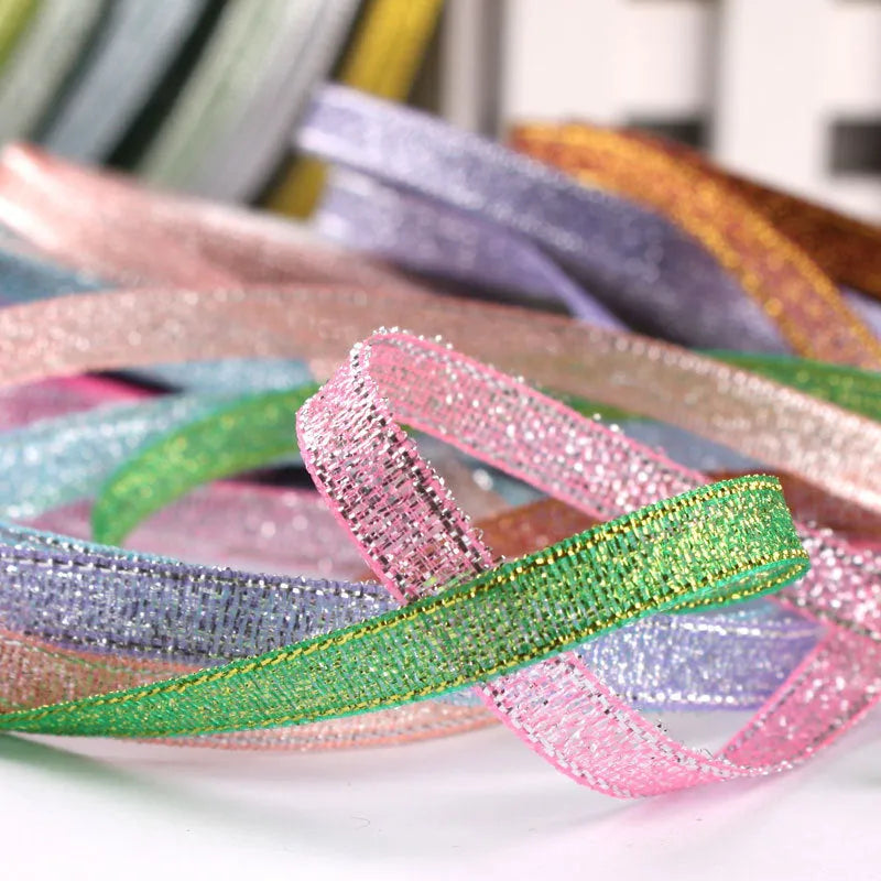 Roll of thin 0.6cm wide polyester ribbon in a selection of 22 colours including metallic gold and sky blue.