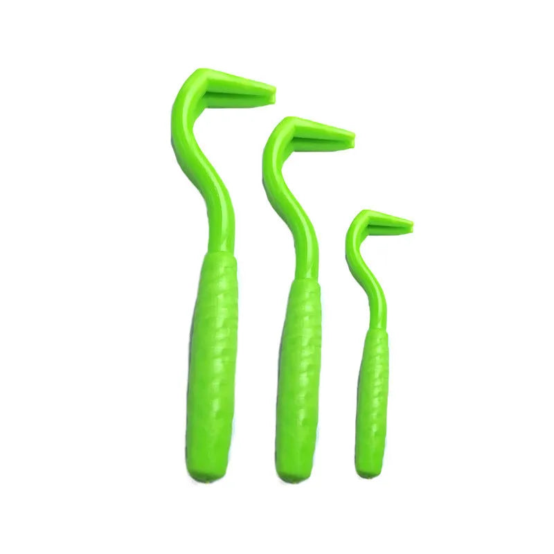 Pack of three coloured plastic tick removal hooks for dogs on a plain background.