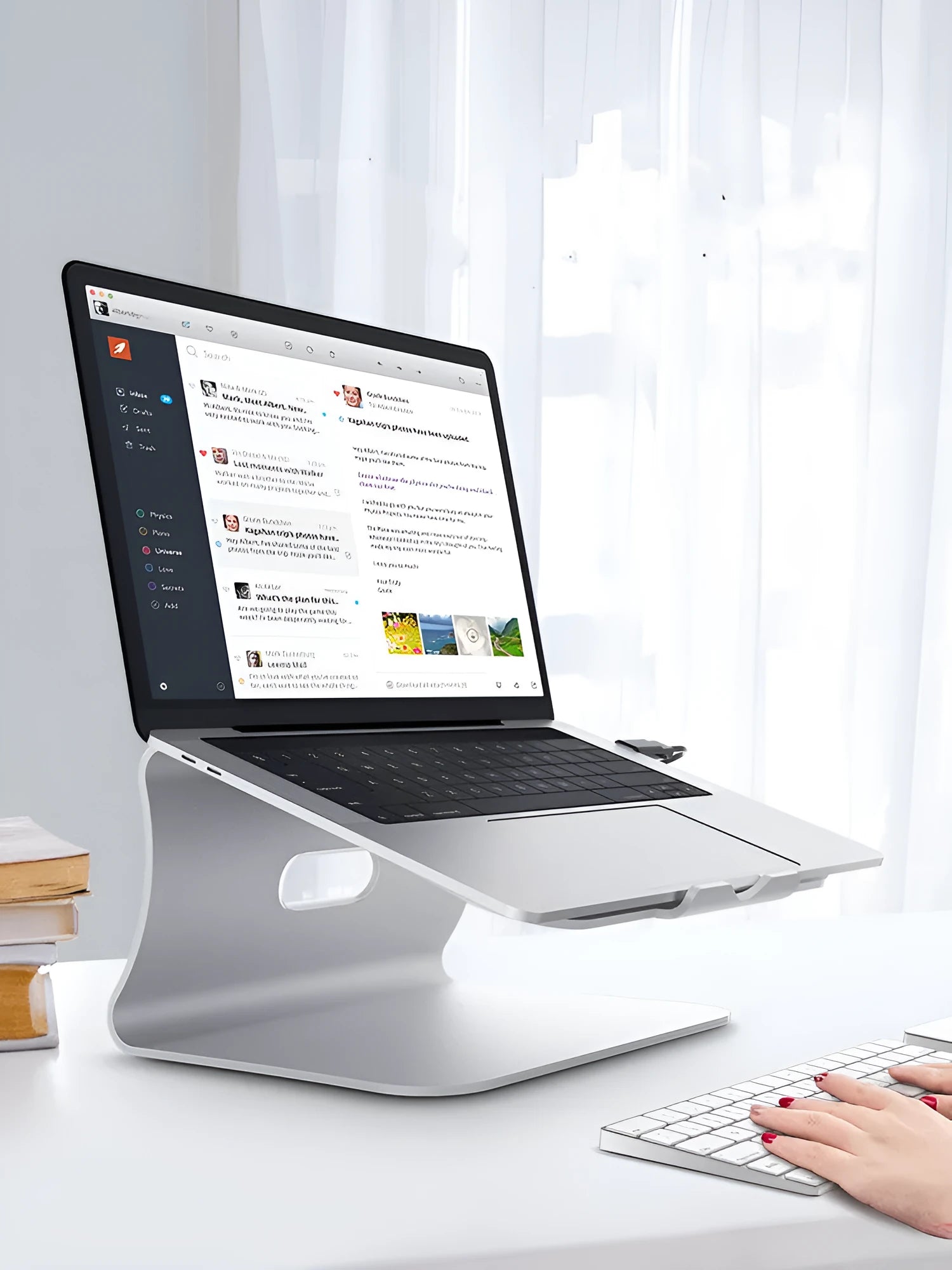 Silver aluminium laptop cooling stand with rotary base, 4.07mm thick, on a wooden desk.