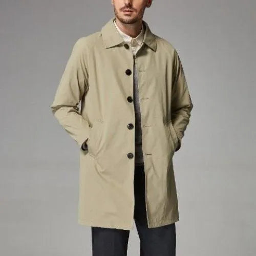 Man wearing a khaki-coloured, loose-fit mid-length trench coat made of rabbit fur.