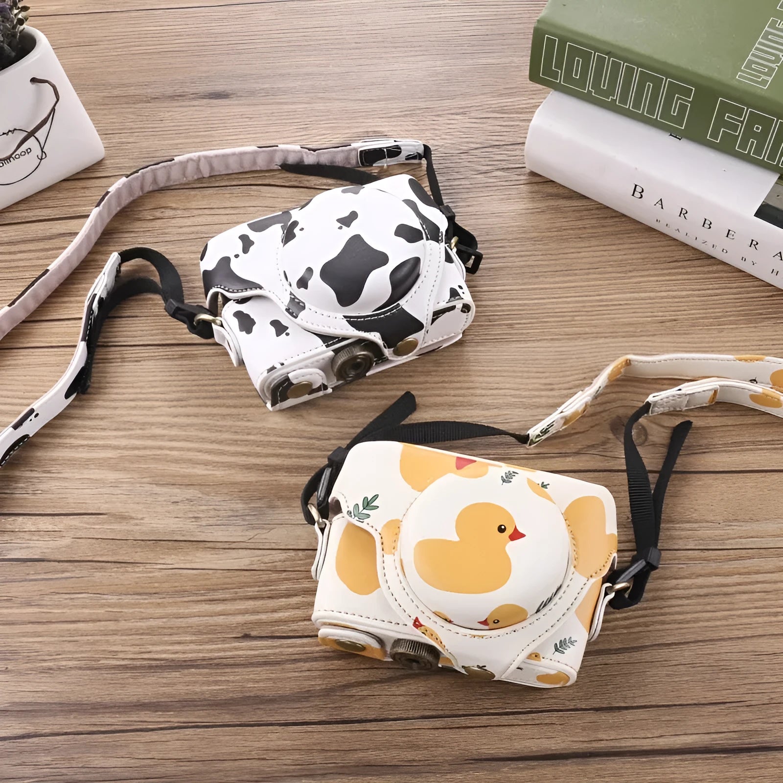 Black imitation leather portable card camera bag with crossbody strap on a solid background