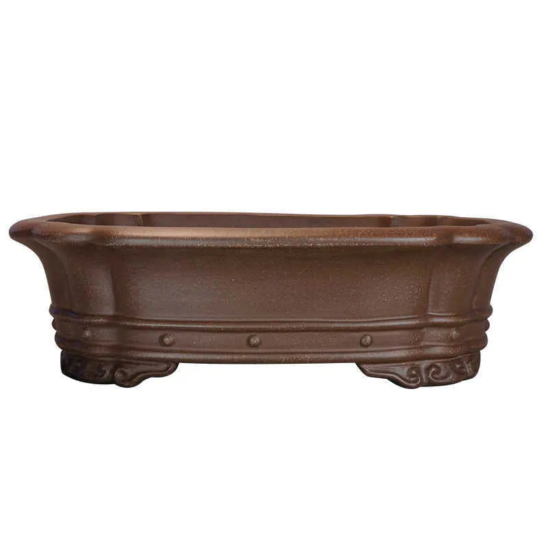 Handmade purple sand rectangular antique begonia flower pot on a desktop.