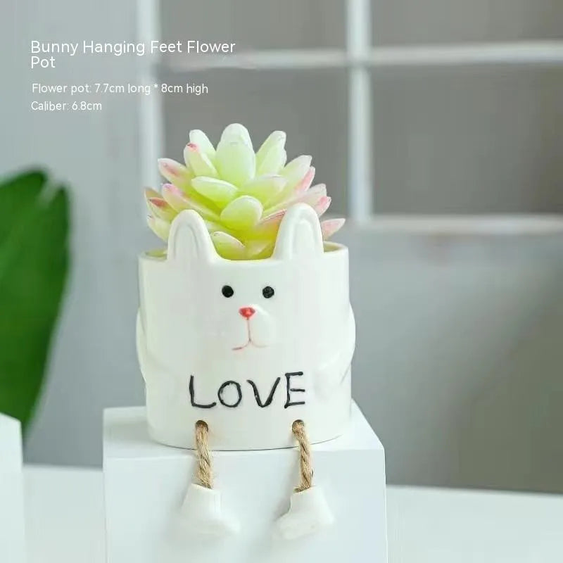 Cartoon-style ceramic hanging foot flower pot for succulent plants on a desktop.