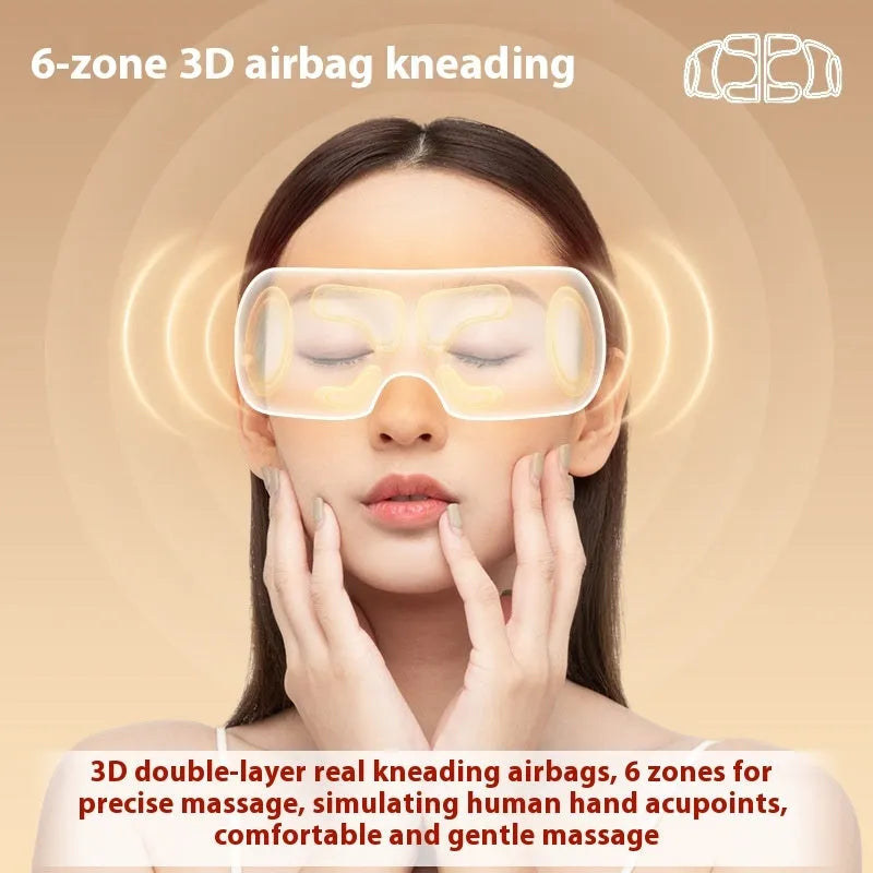 White rechargeable eye massager with hot compress and airbag functions on a table