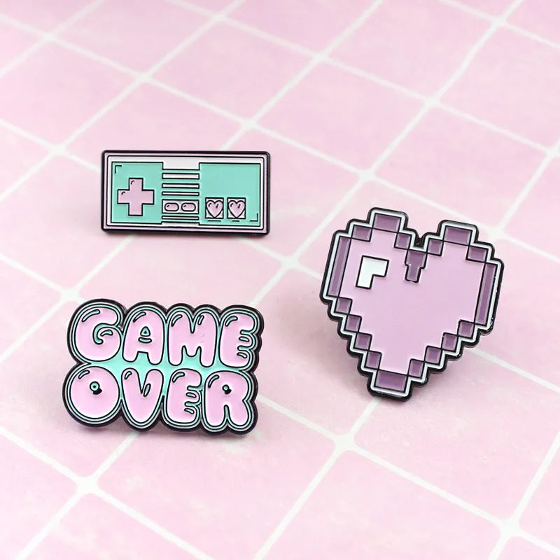 Stereo game console badge made of alloy metal in a three-dimensional design, shown in its OPP packaging.