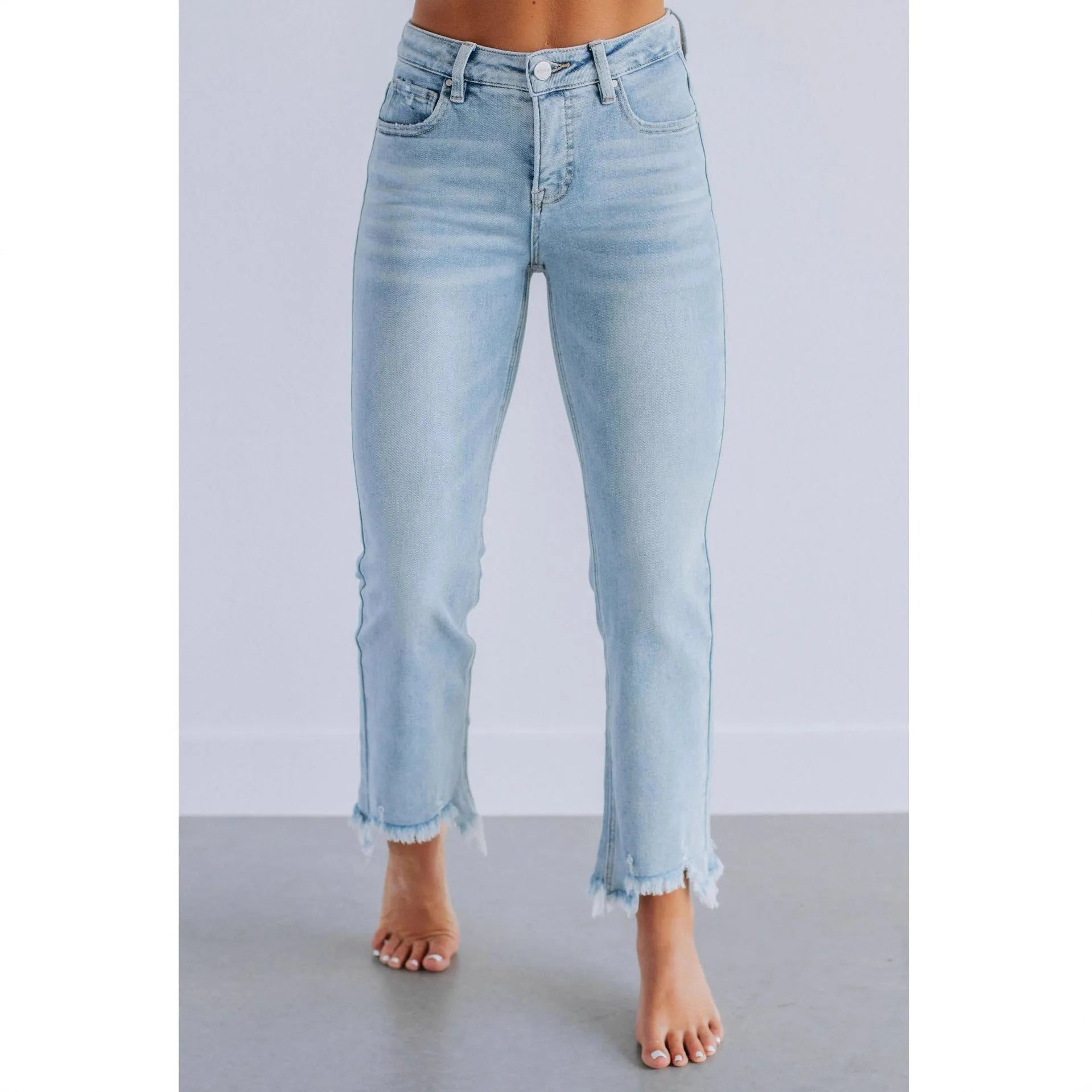 A pair of women's solid colour denim trousers with a manual wear finish, shown in dark blue.