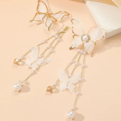 White butterfly earrings with lace design, pearl accents, rhinestones, and tassel on electroplated copper alloy