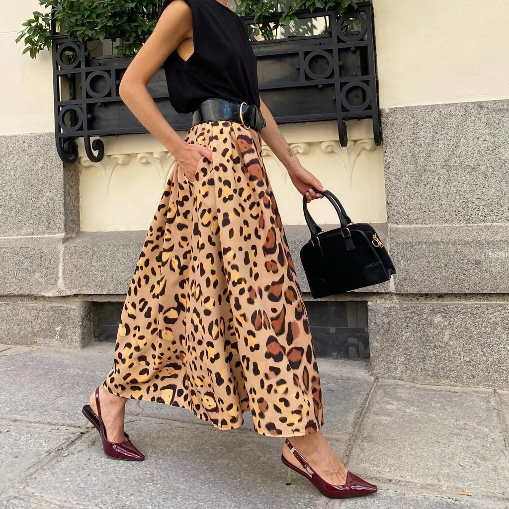 Brown leopard print women's long A-line skirt with a wide, flowing hem on a hanger.