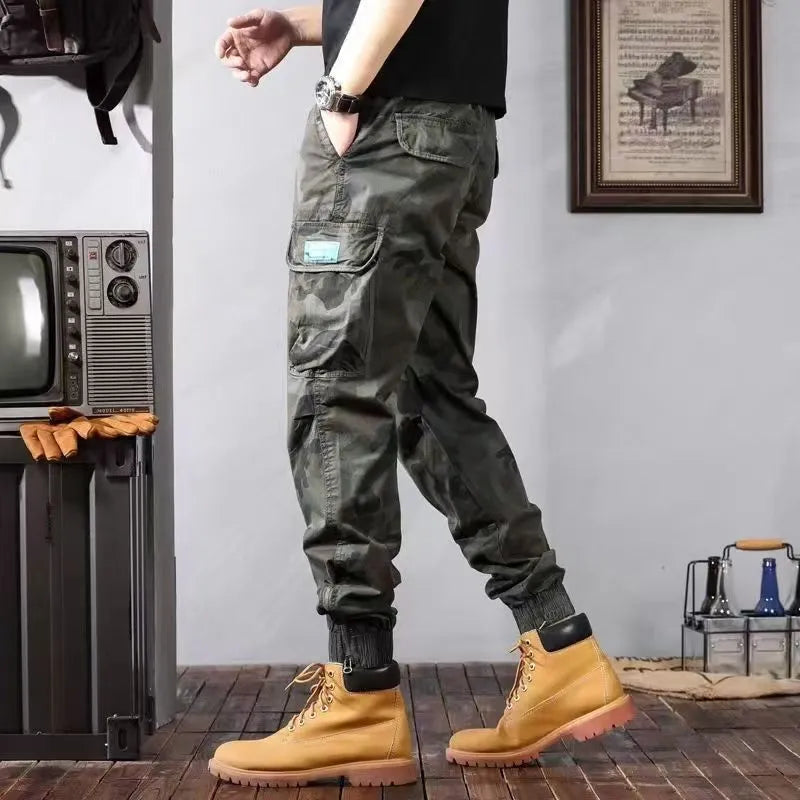 Men's camouflage cargo pants in Army Green, loose tapered fit with pockets, polyester cotton.