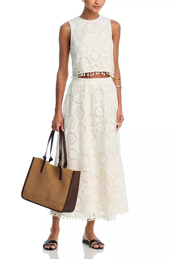 White women's sleeveless top and long skirt suit with embroidery details