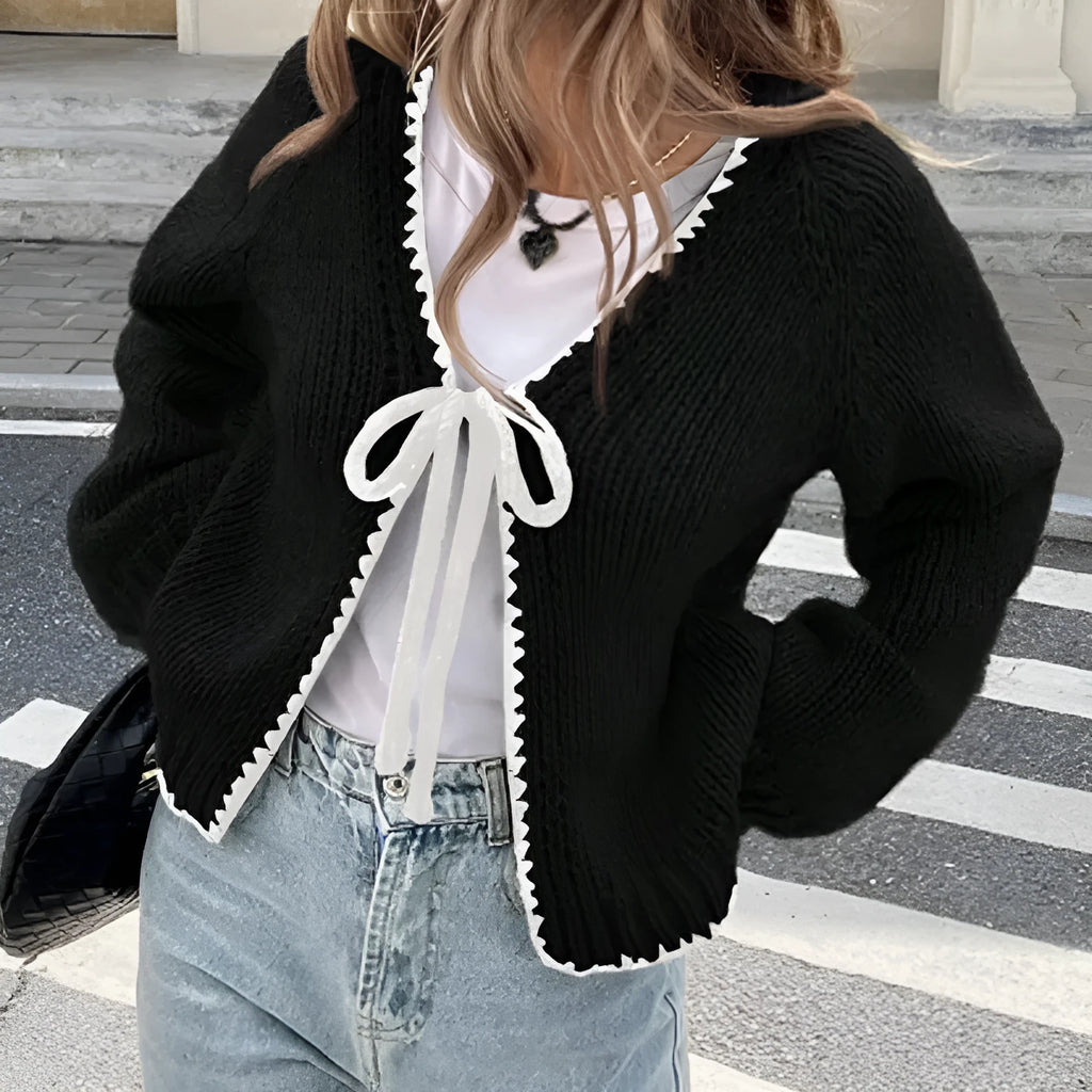 Lace-up cardigan sweater with crocheted flower detailing in solid colour