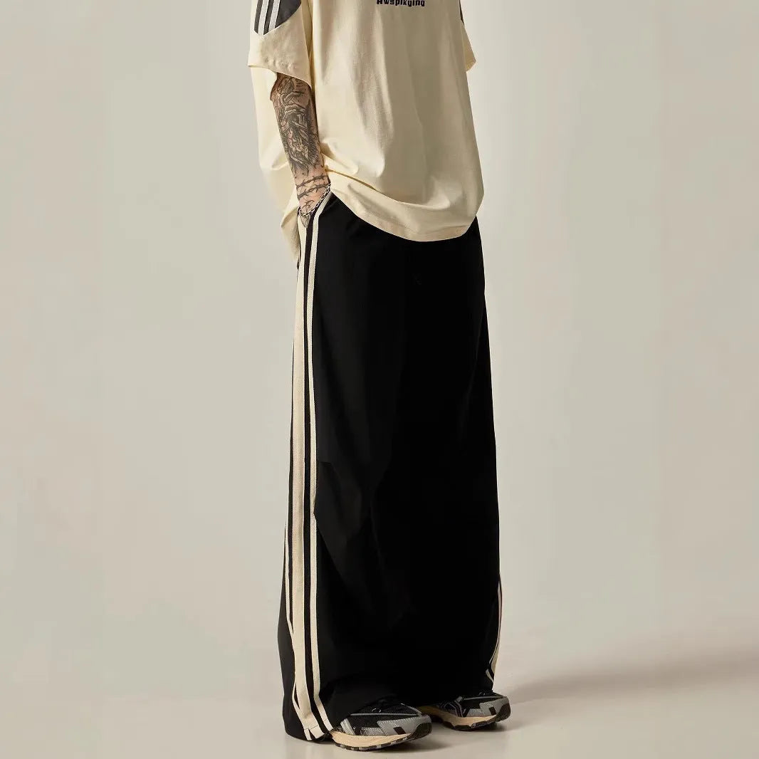 Black high-waist wide-leg climbing trousers for men laid flat, showing straight-leg style.