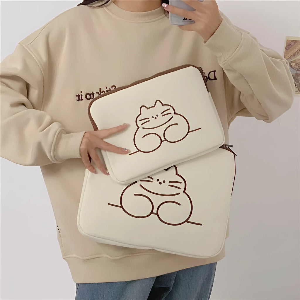 Embroidered fat cat design on a grey nylon tablet protective sleeve with a black metal zipper.