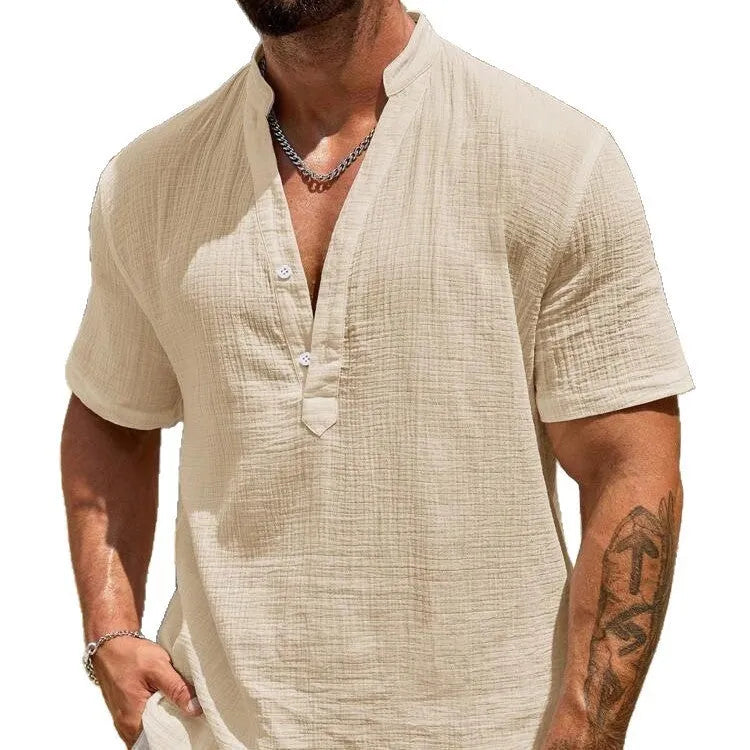 Man wearing a thin light blue stand collar short-sleeved casual shirt.