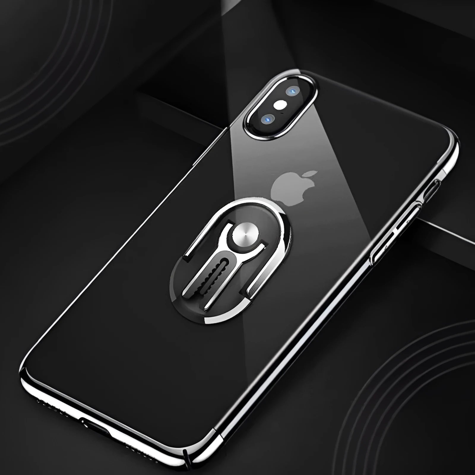 Universal black car phone ring bracket mounted on a car dashboard holding a mobile phone.