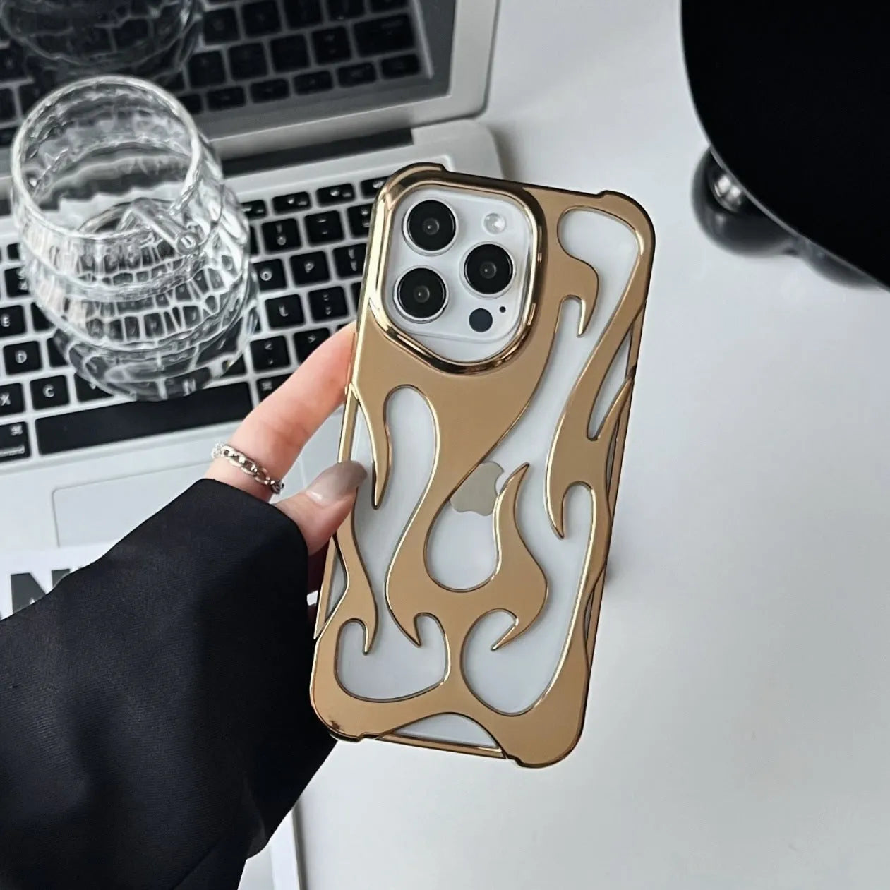Electroplated hollow flame pattern phone case for iPhone, showing silver finish and perforated design for heat dissipation.