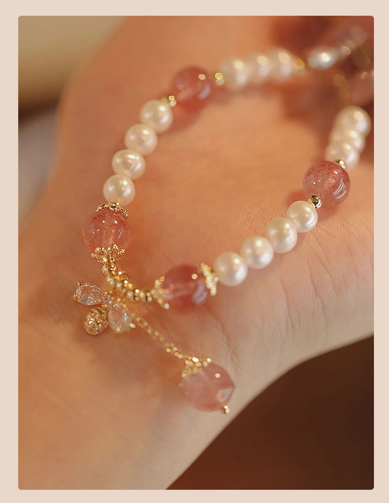 Handmade women's strawberry quartz crystal bracelet with a decorative bow clasp.