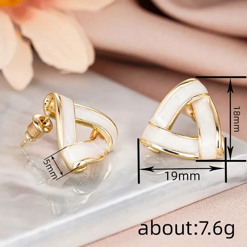 Women's metal oil stud earrings with inlaid zircon, geometric triangle shape, yellow gold finish on copper