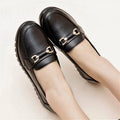 Black soft leather casual pumps with a round toe and low flat heel.