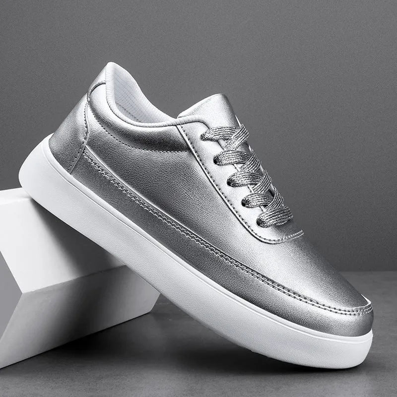 Women's leather flat casual shoes in gold colour with front lace-up closure on a white background.