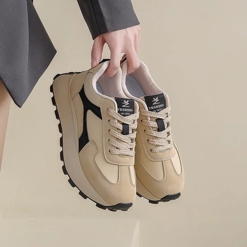 Women's solid colour platform sneakers with lace-up front and flat rubber sole.