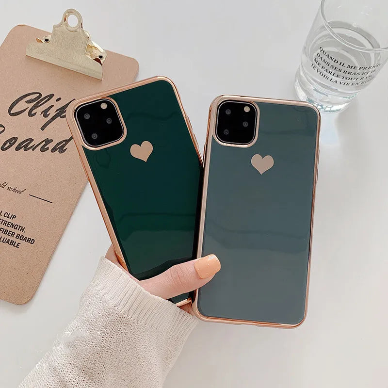Solid colour TPU back cover case for iPhone on a table, showing blue, claret, pink, and green options.
