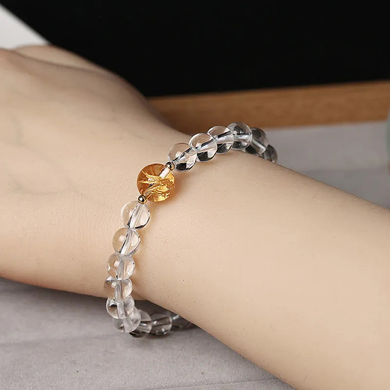 Unisex geometric bead bracelet with black obsidian agate and white crystal stones on a wrist