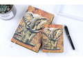 PU leather A5 notebook with three-dimensional embossed cover and bronze highlights, open to beige pages
