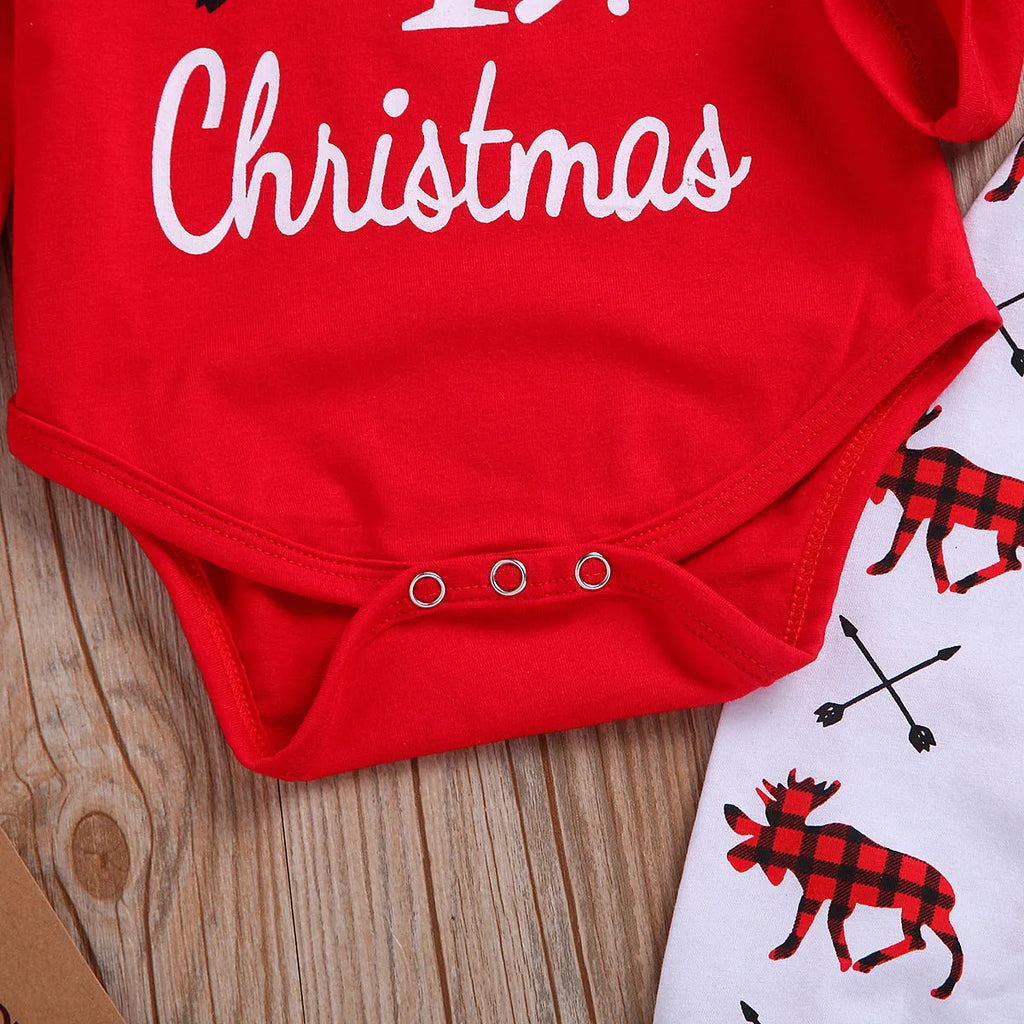 Girls' red Christmas suit with cartoon print top and trousers on white background