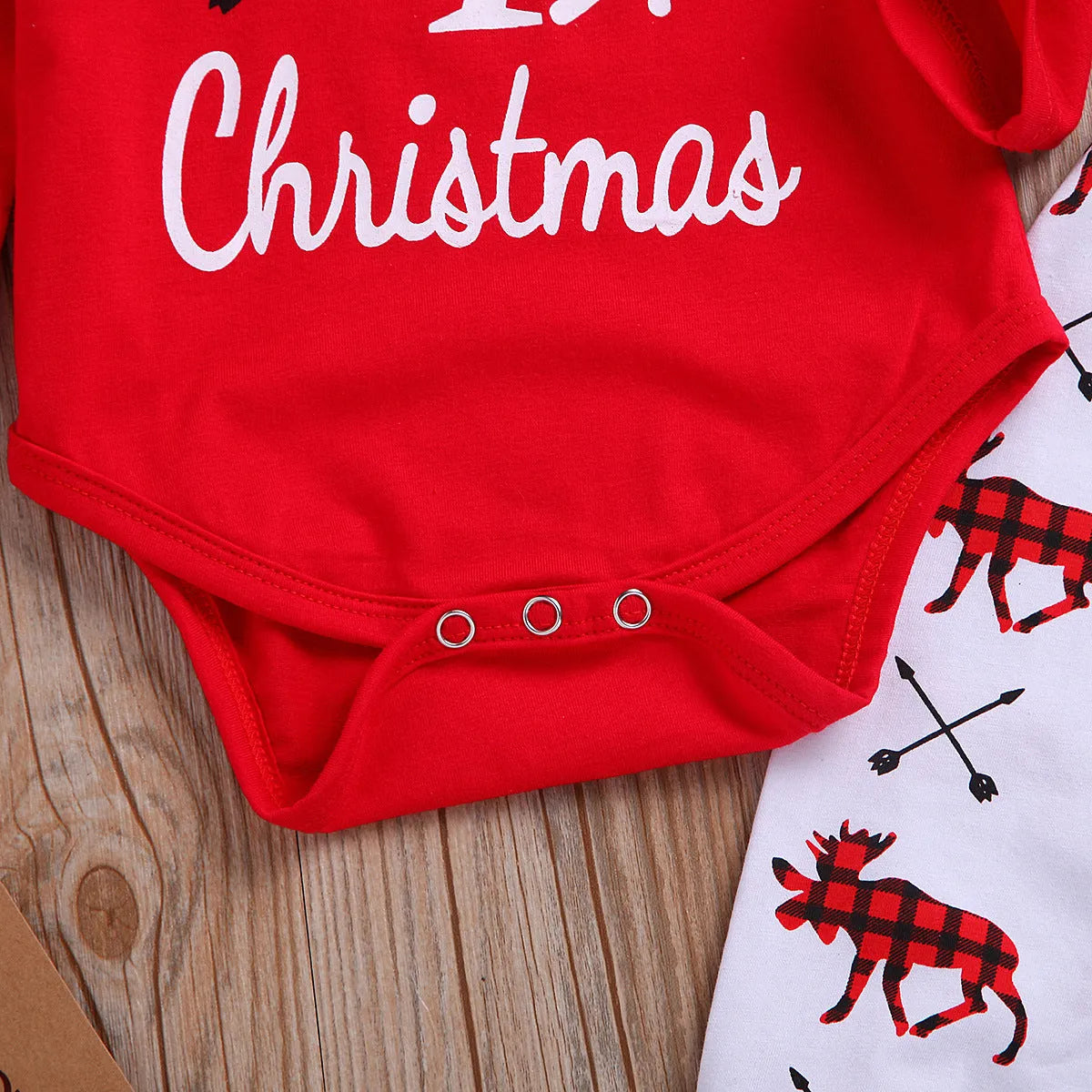 Girls' red Christmas suit with cartoon print top and trousers on white background
