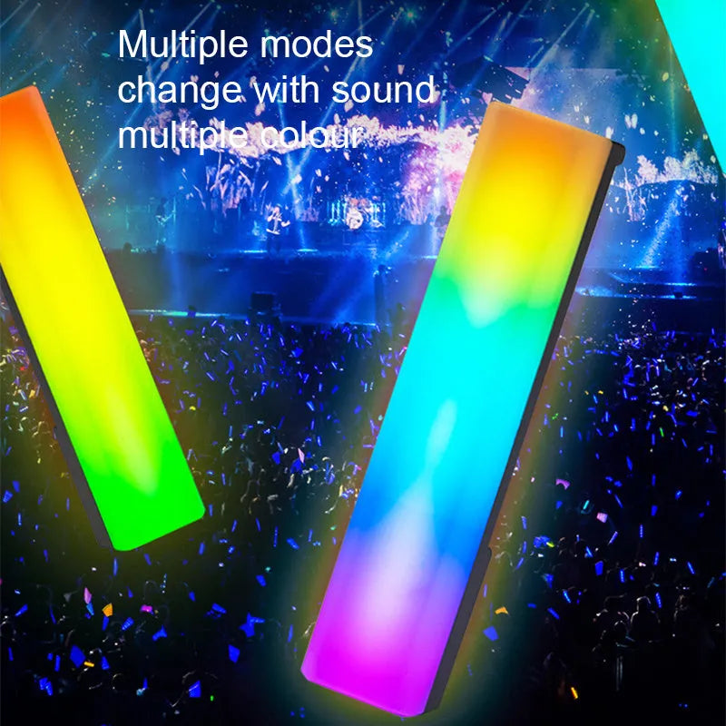 A tall, colourful RGB table lamp with a white or black shell reacting to sound on a desk.